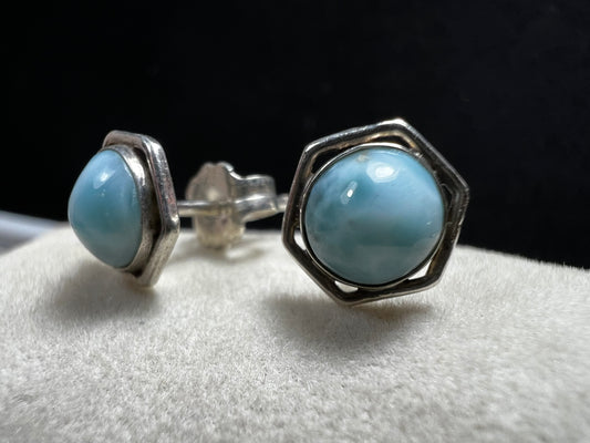 These sterling silver earrings feature natural larimar cabochons from the Dominican Republic set in a hexagon bezel, perfect for a touch of Caribbean charm.