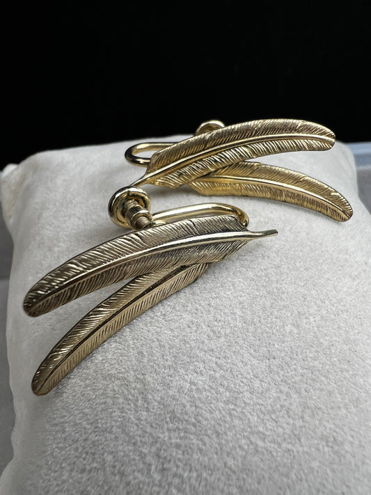 These vintage gold-filled earrings each feature two detailed feathers, offering a unique touch to your style.