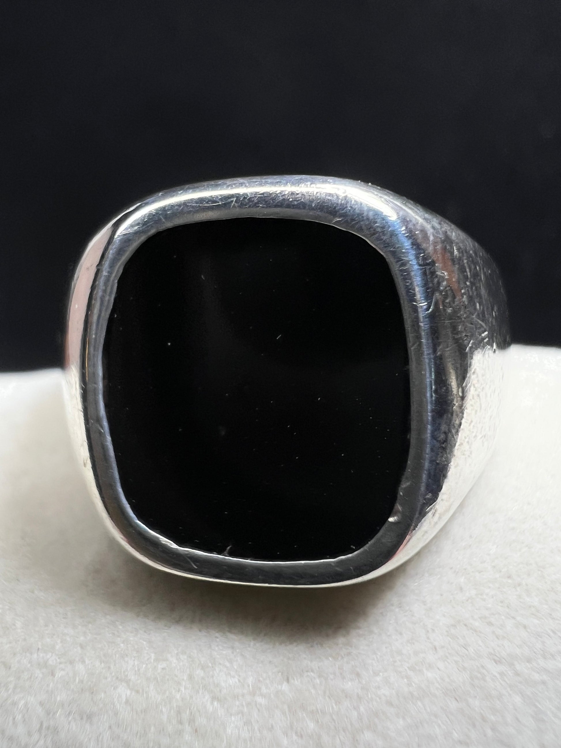 This vintage Avon ring combines sterling silver craftsmanship with a bold onyx centerpiece, designed to make a distinctive statement. Sized at 12.5, its unisex design suits both men and women seeking a timeless accessory with elegant presence.