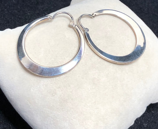 These 1 1/4" sterling silver hoop earrings are crafted with solid construction to ensure durability and lasting wear. Their timeless design offers a versatile accessory that complements any outfit.