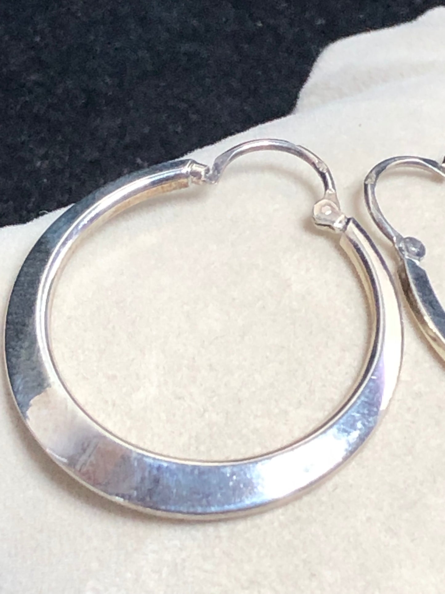 These 1 1/4" sterling silver hoop earrings are crafted with solid construction to ensure durability and lasting wear. Their timeless design offers a versatile accessory that complements any outfit.