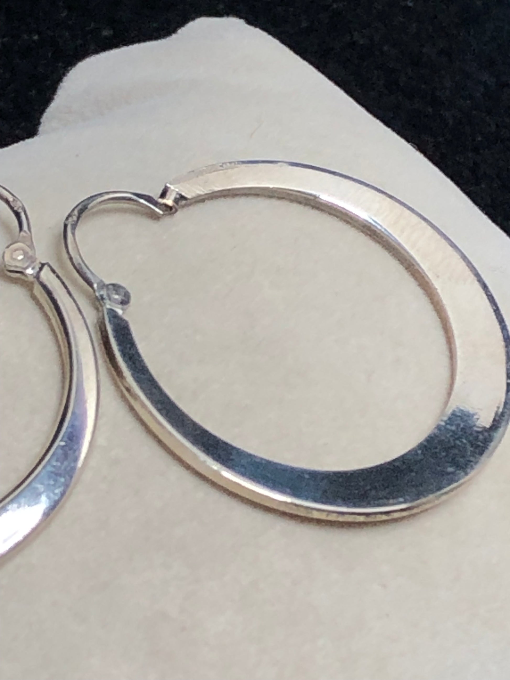 These 1 1/4" sterling silver hoop earrings are crafted with solid construction to ensure durability and lasting wear. Their timeless design offers a versatile accessory that complements any outfit.