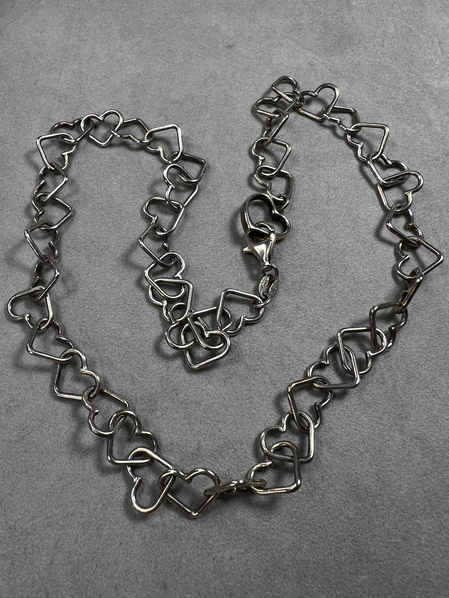 This 18" sterling silver necklace by Milor Italy showcases distinctive heart-shaped links, blending craftsmanship with elegant design. The unique link pattern is perfect for expressing personal style.