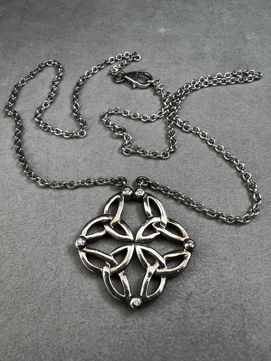 This stunning sterling silver necklace from Keith Jack features an intricate Celtic-inspired pendant, symbolizing eternity and unity. The pendant opens up for a different look when desired. The design is accented with four genuine diamonds, adding just the right amount of sparkle and elegance.