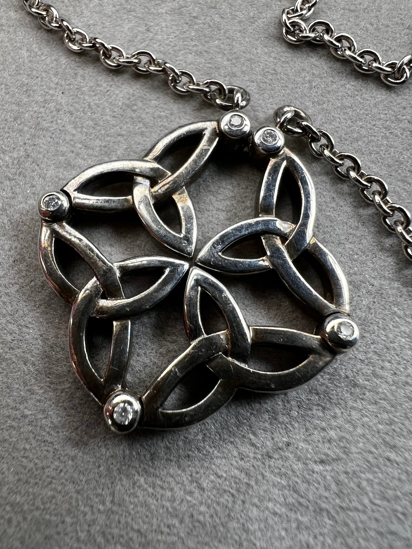 This stunning sterling silver necklace from Keith Jack features an intricate Celtic-inspired pendant, symbolizing eternity and unity. The pendant opens up for a different look when desired. The design is accented with four genuine diamonds, adding just the right amount of sparkle and elegance.