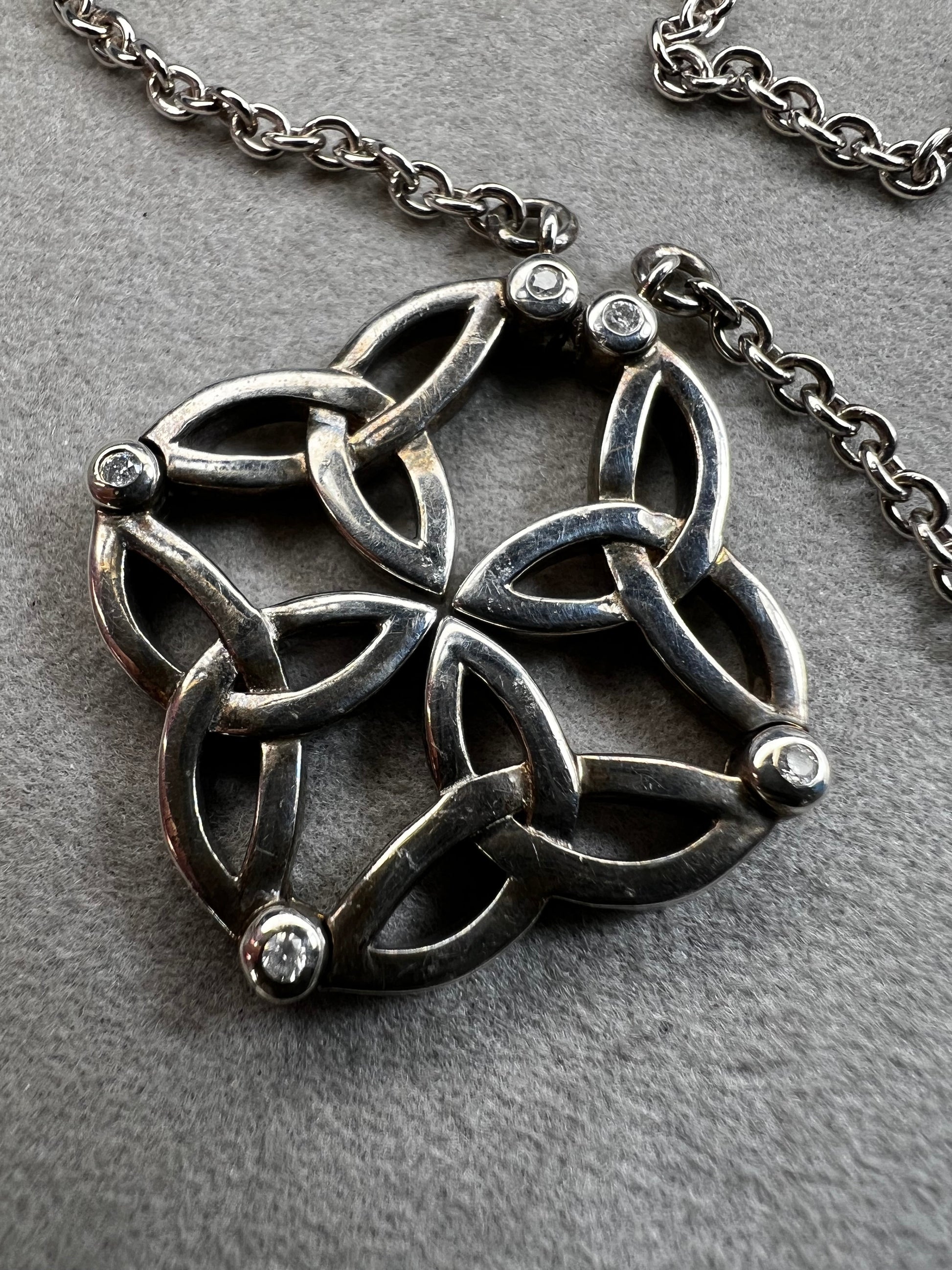 This stunning sterling silver necklace from Keith Jack features an intricate Celtic-inspired pendant, symbolizing eternity and unity. The pendant opens up for a different look when desired. The design is accented with four genuine diamonds, adding just the right amount of sparkle and elegance.