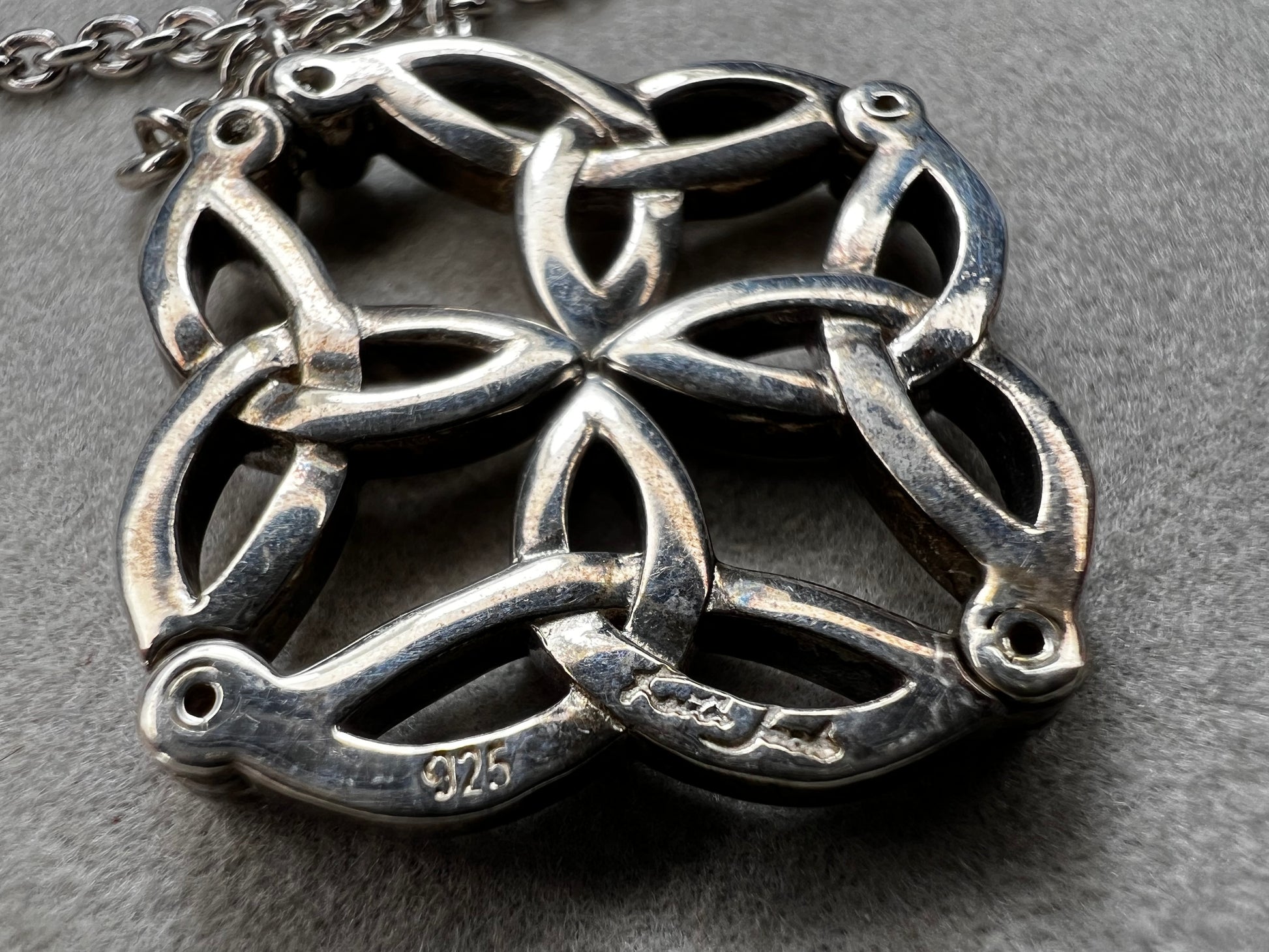 This stunning sterling silver necklace from Keith Jack features an intricate Celtic-inspired pendant, symbolizing eternity and unity. The pendant opens up for a different look when desired. The design is accented with four genuine diamonds, adding just the right amount of sparkle and elegance.
