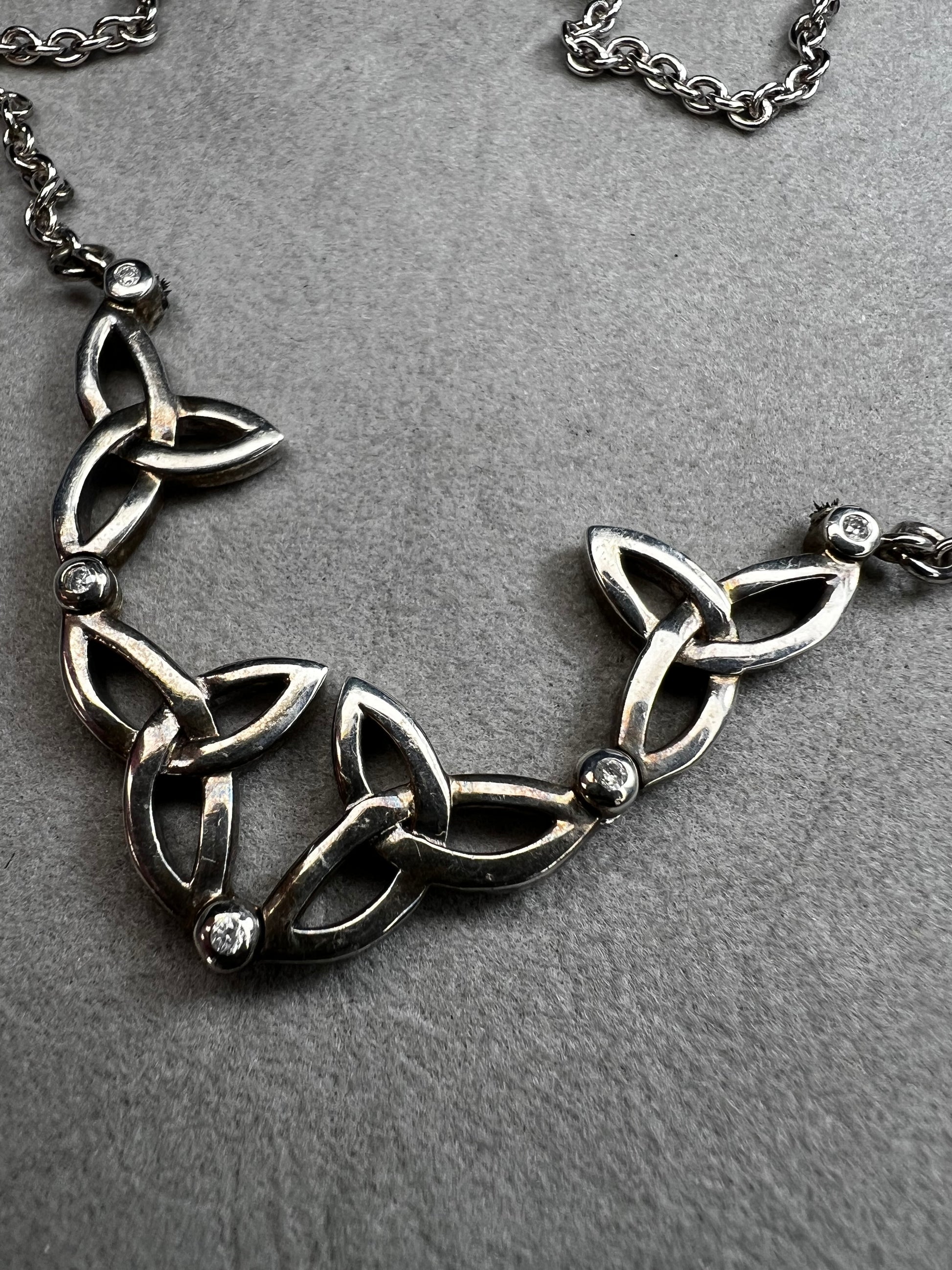 This stunning sterling silver necklace from Keith Jack features an intricate Celtic-inspired pendant, symbolizing eternity and unity. The pendant opens up for a different look when desired. The design is accented with four genuine diamonds, adding just the right amount of sparkle and elegance.