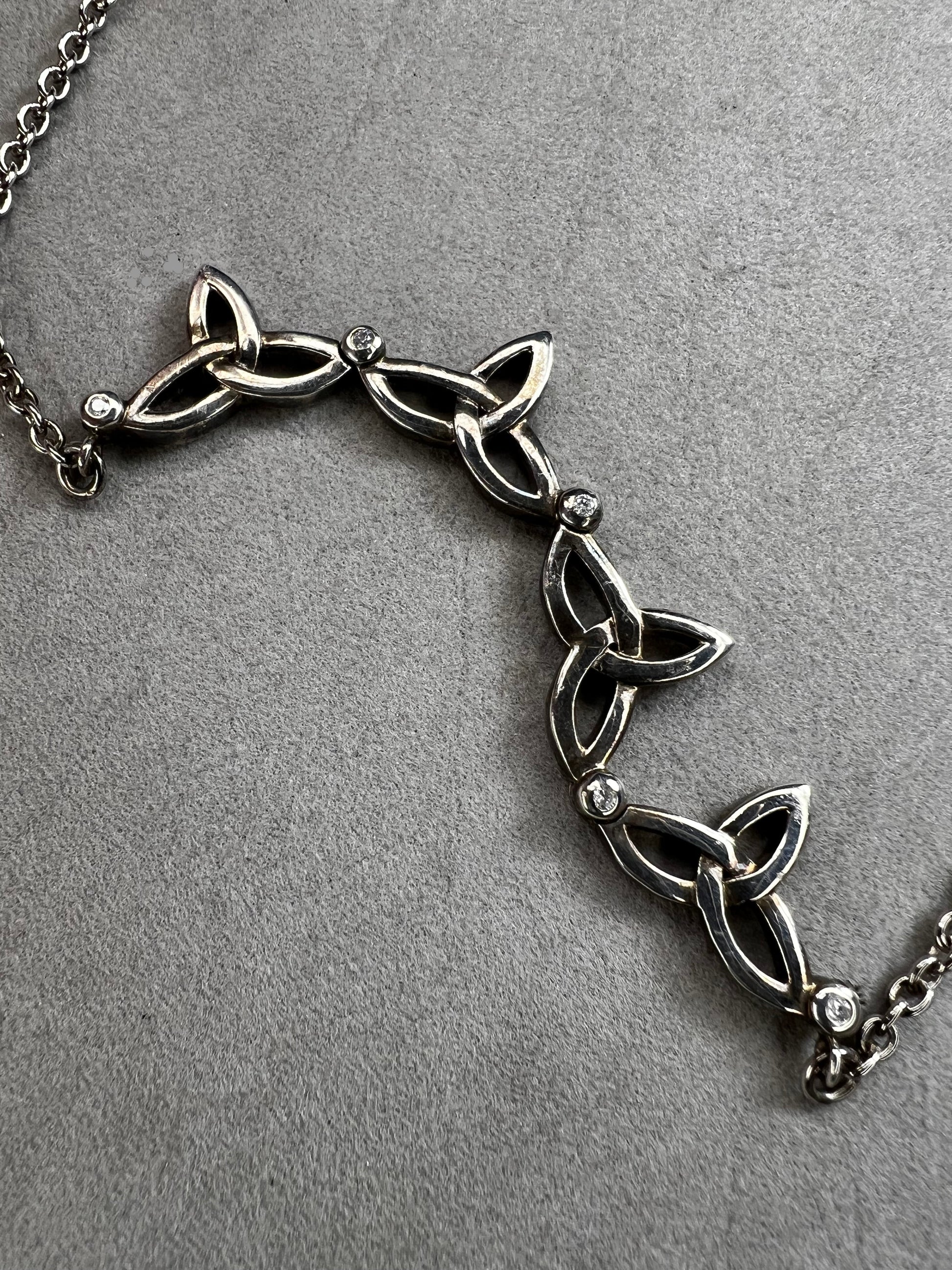 This stunning sterling silver necklace from Keith Jack features an intricate Celtic-inspired pendant, symbolizing eternity and unity. The pendant opens up for a different look when desired. The design is accented with four genuine diamonds, adding just the right amount of sparkle and elegance.