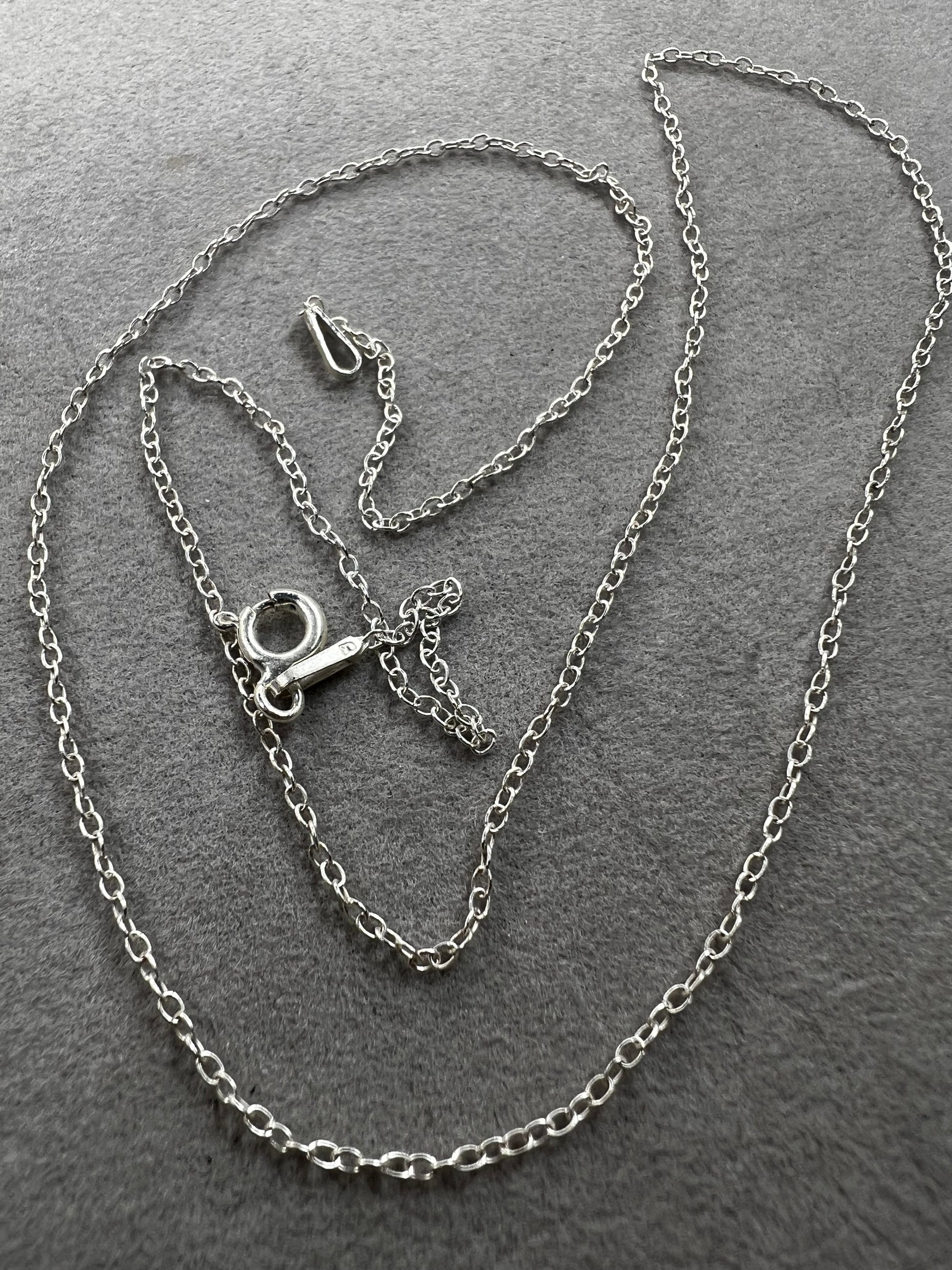 This petite sterling silver chain features a classic cable link, making it a versatile piece for your collection. It works on its own or layered with other necklaces -- or pair it with one of our small pendants.