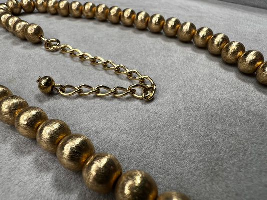 This 16" necklace features a gold-filled chain accented with gold-filled beads, designed to catch the light beautifully with every movement. It offers a refined yet versatile addition to elevate any wardrobe.