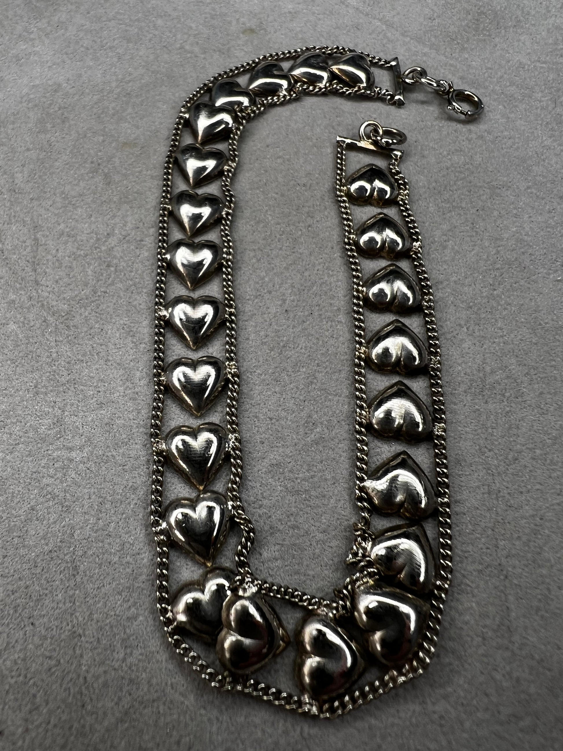 This vintage sterling silver chain and heart bracelet combines timeless durability with elegant design. Crafted from high-quality sterling silver, it offers a lasting piece that carries sentimental value.