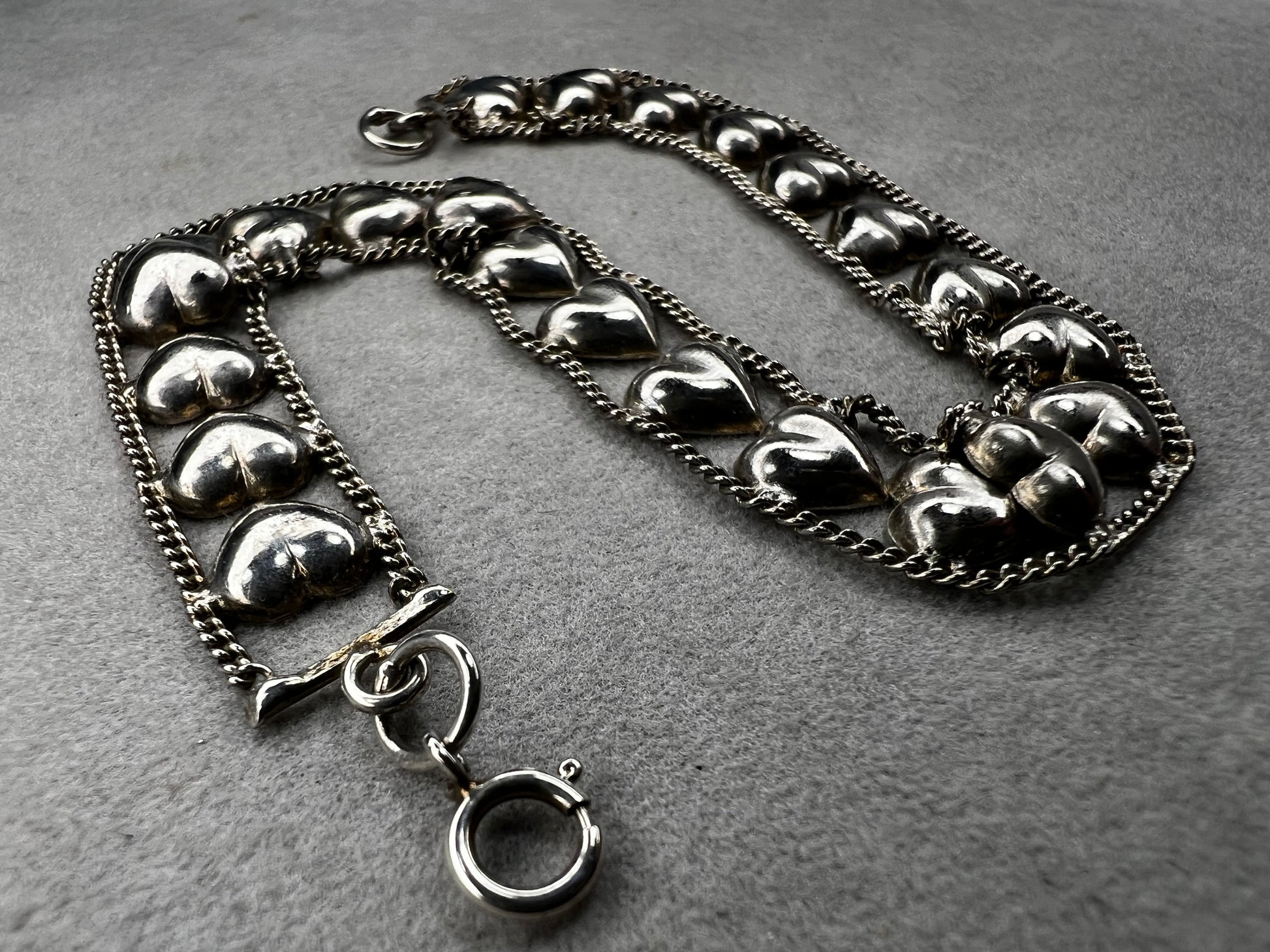 This vintage sterling silver chain and heart bracelet combines timeless durability with elegant design. Crafted from high-quality sterling silver, it offers a lasting piece that carries sentimental value.