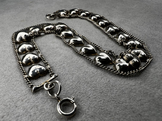 This vintage sterling silver chain and heart bracelet combines timeless durability with elegant design. Crafted from high-quality sterling silver, it offers a lasting piece that carries sentimental value.