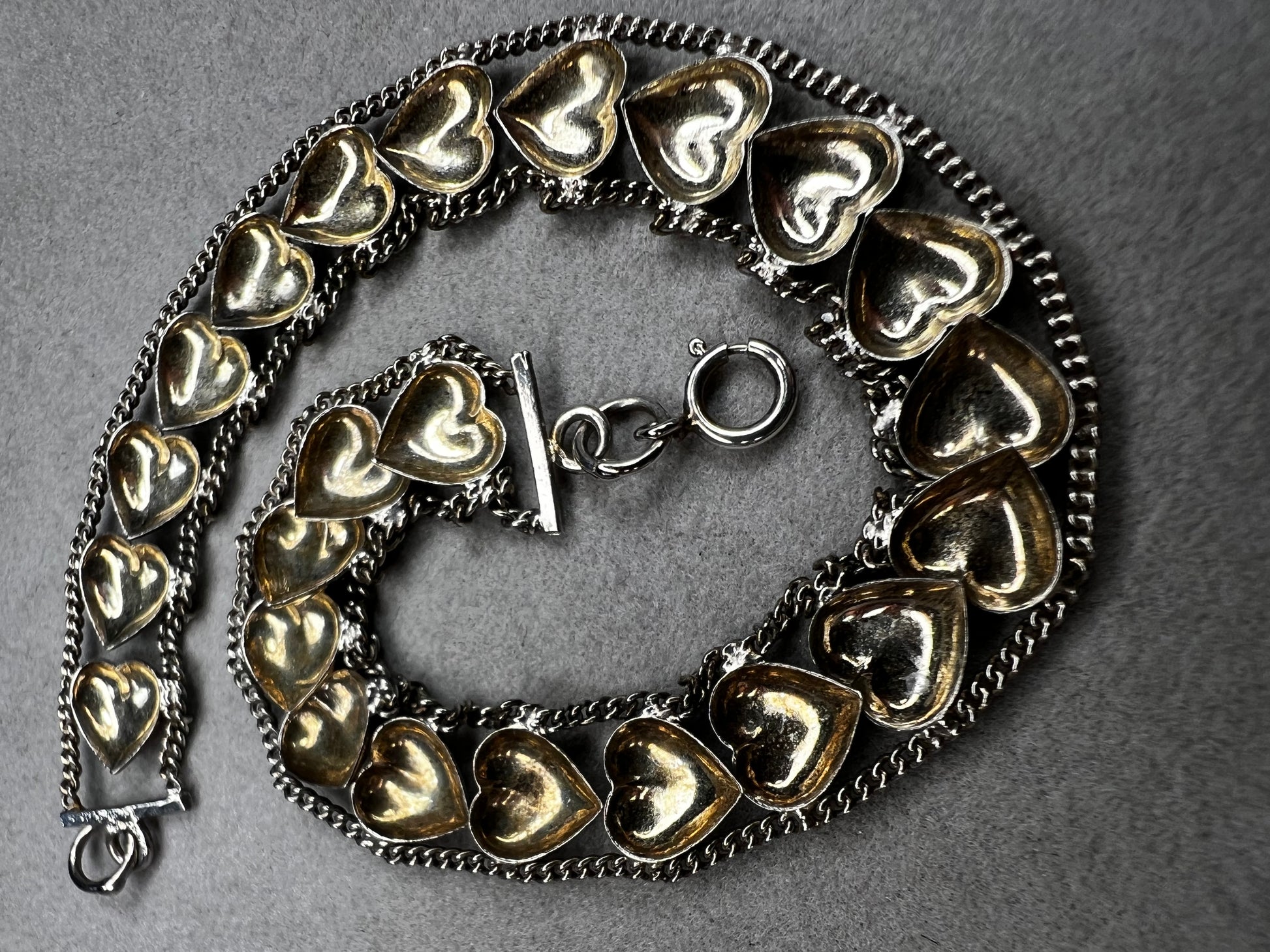 This vintage sterling silver chain and heart bracelet combines timeless durability with elegant design. Crafted from high-quality sterling silver, it offers a lasting piece that carries sentimental value.