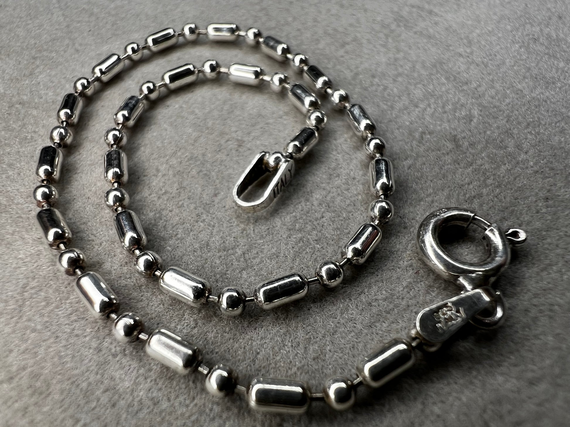 This sterling silver bracelet features an expertly crafted bead-and-tube link design, offering a distinctive alternative to traditional chains.