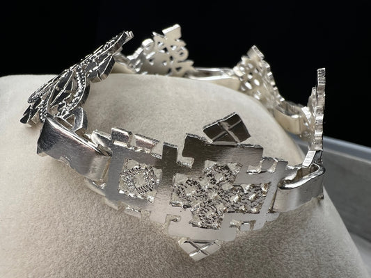 Crafted in sterling silver, this vintage bracelet features five ornate openwork panels. A timeless design that makes a striking statement.