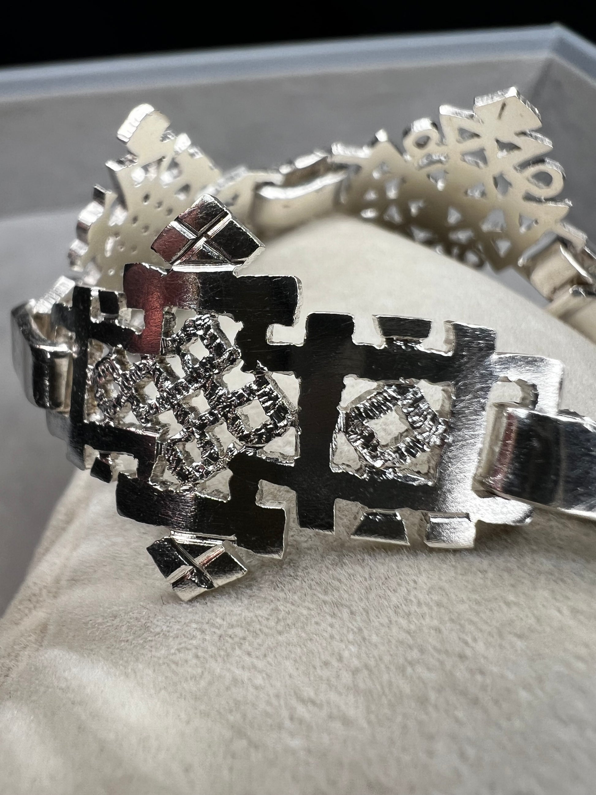 Crafted in sterling silver, this vintage bracelet features five ornate openwork panels. A timeless design that makes a striking statement.