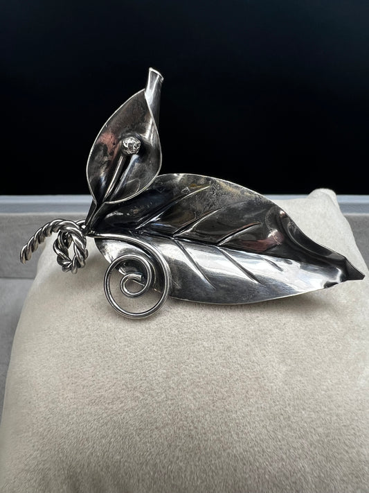 This sterling silver brooch features detailed craftsmanship that captures the beauty of nature -- perfect for anyone who loves the outdoors.