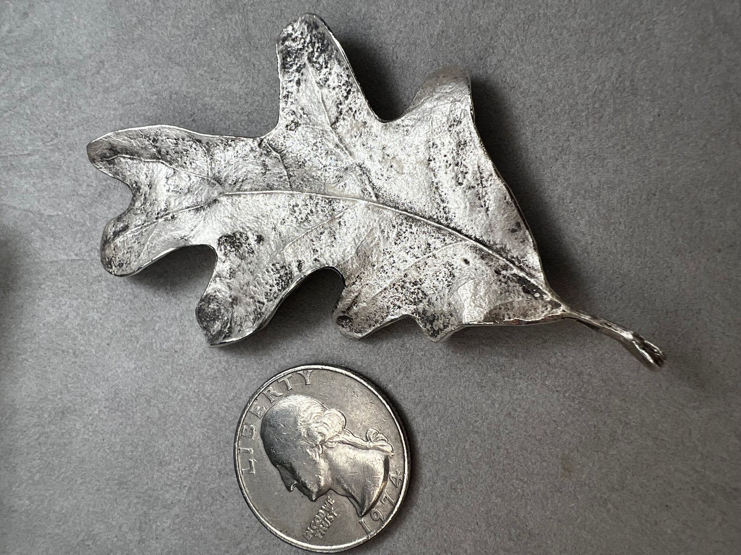 Shaped like an oak leaf, this sterling silver brooch captures nature’s beauty in exquisite detail. Its realistic design makes it a standout piece wherever it’s worn.