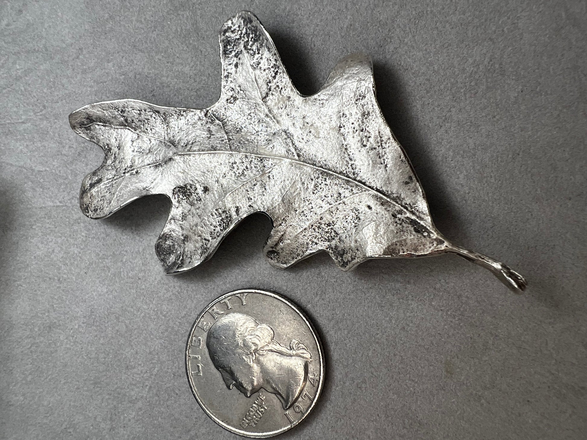 Shaped like an oak leaf, this sterling silver brooch captures nature’s beauty in exquisite detail. Its realistic design makes it a standout piece wherever it’s worn.