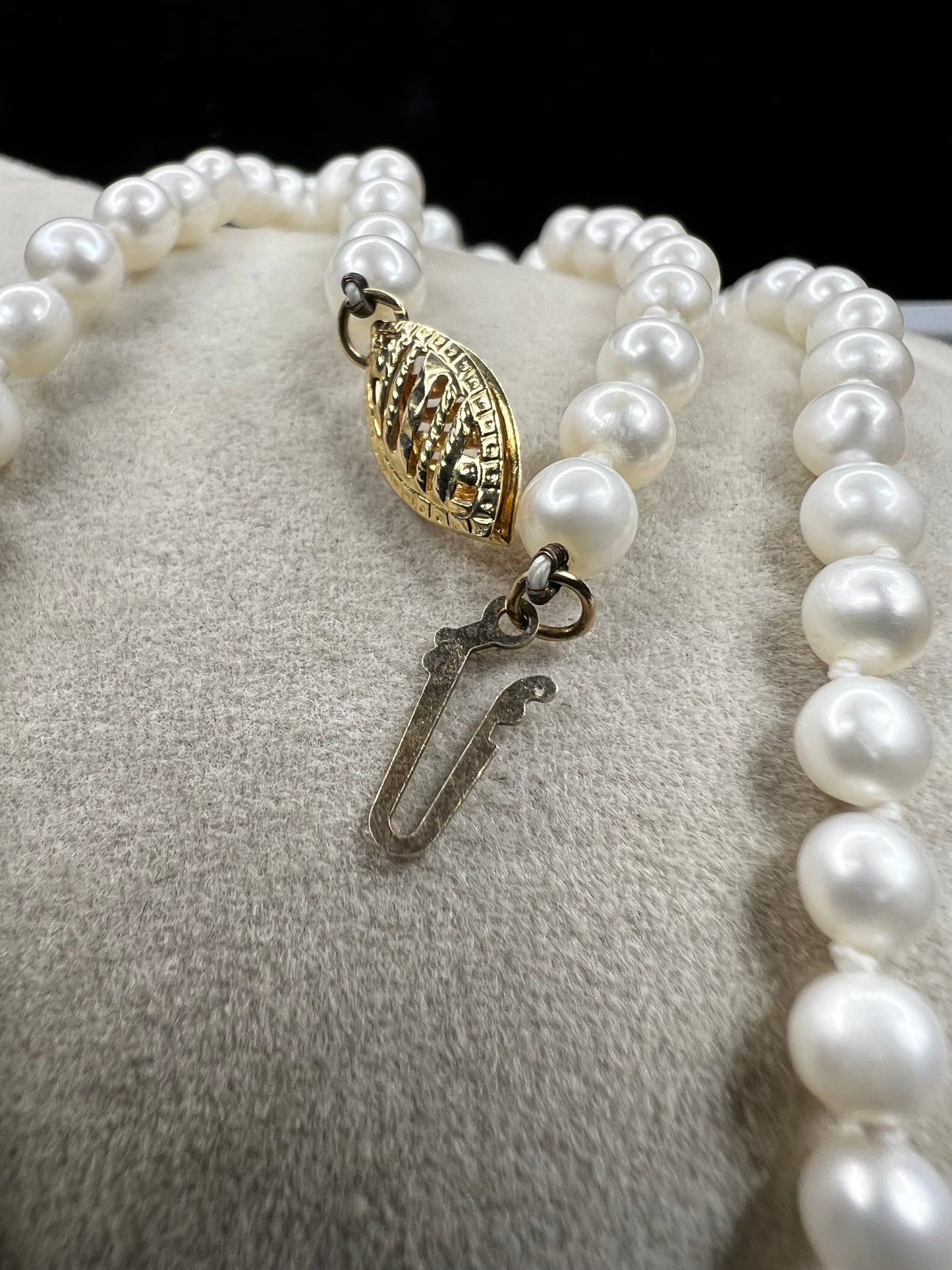 This designer necklace features cultured pearls and a detailed 14k gold clasp. Signed RAFKA, this necklace could be just what you're looking for. Perfect for any season.
