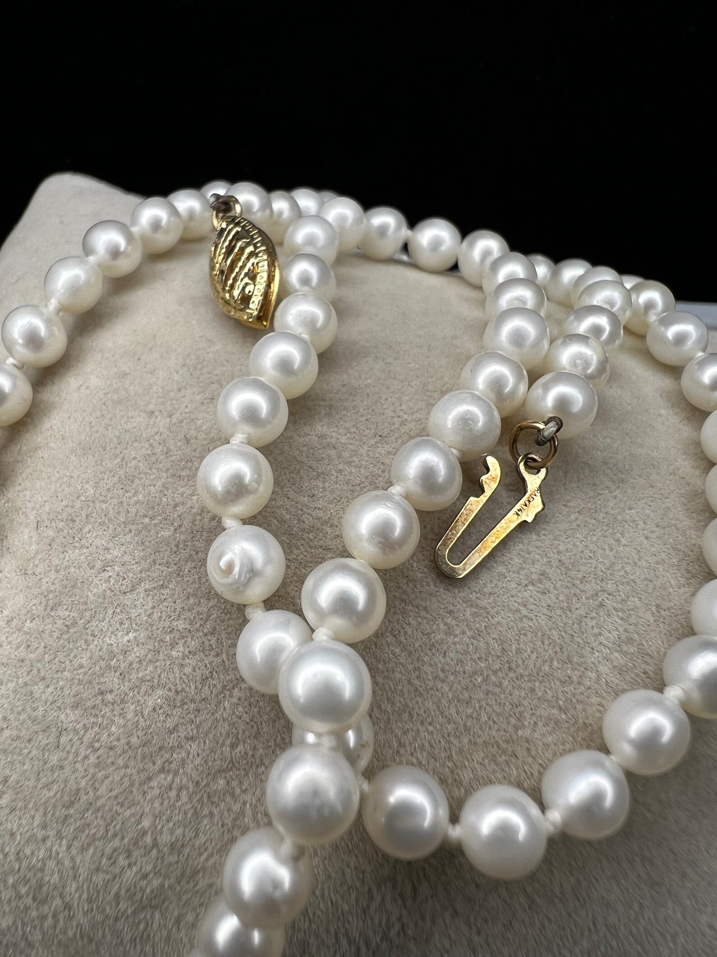 This designer necklace features cultured pearls and a detailed 14k gold clasp. Signed RAFKA, this necklace could be just what you're looking for. Perfect for any season.