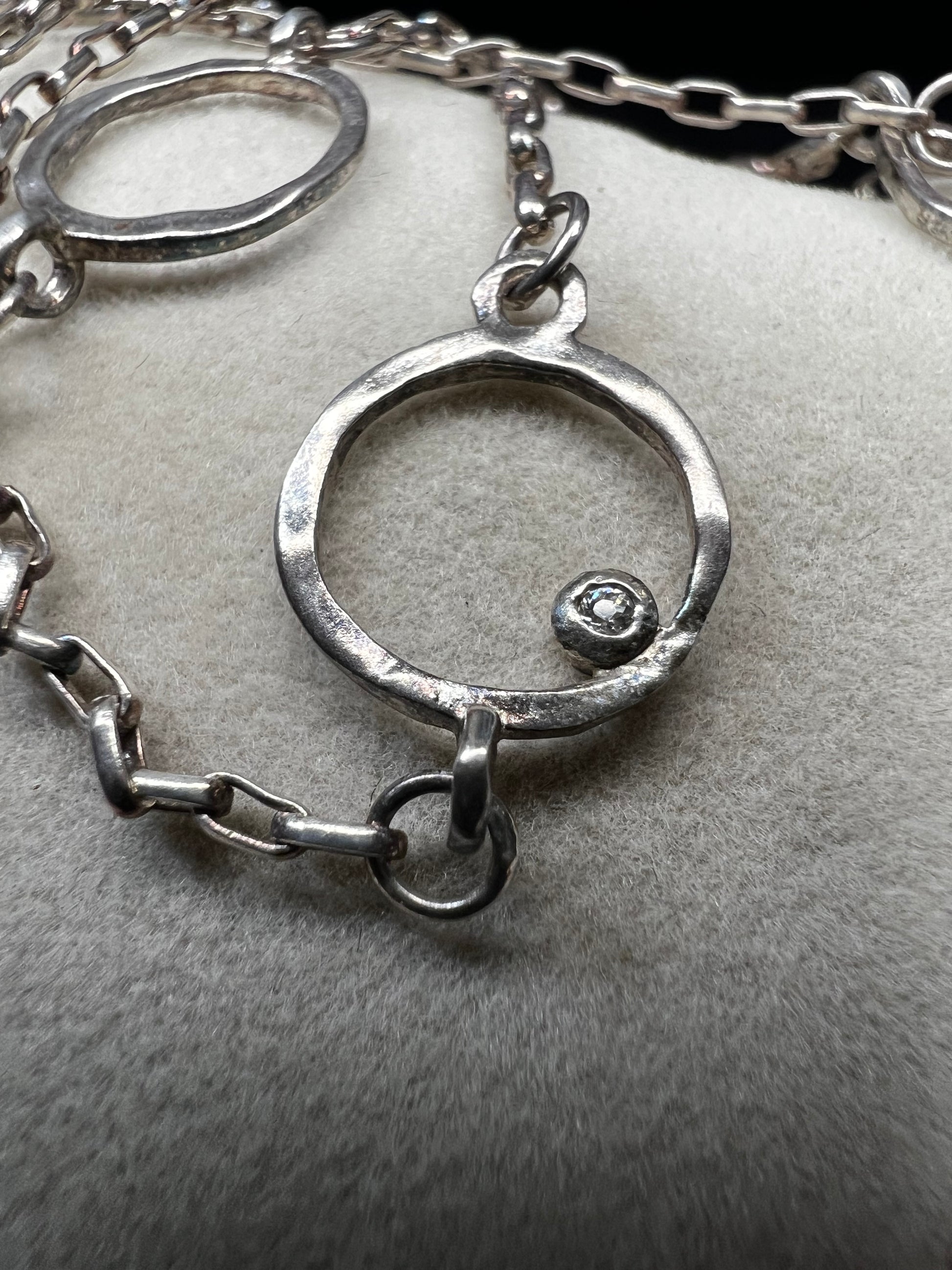 This long sterling silver necklace is designed with intermittent geometric links along the length of the chain. Two of those large links feature a small diamond for a touch of flash in the light. At 34 inches, this can be wrapped twice for a layered look, or it can be worn long. Made by Silpada.