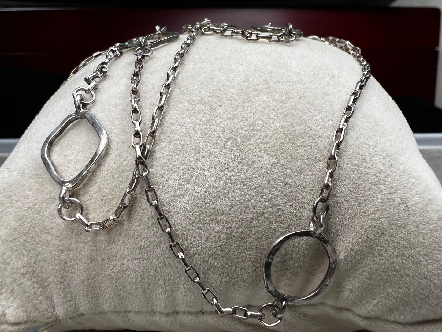 This long sterling silver necklace is designed with intermittent geometric links along the length of the chain. Two of those large links feature a small diamond for a touch of flash in the light. At 34 inches, this can be wrapped twice for a layered look, or it can be worn long. Made by Silpada.