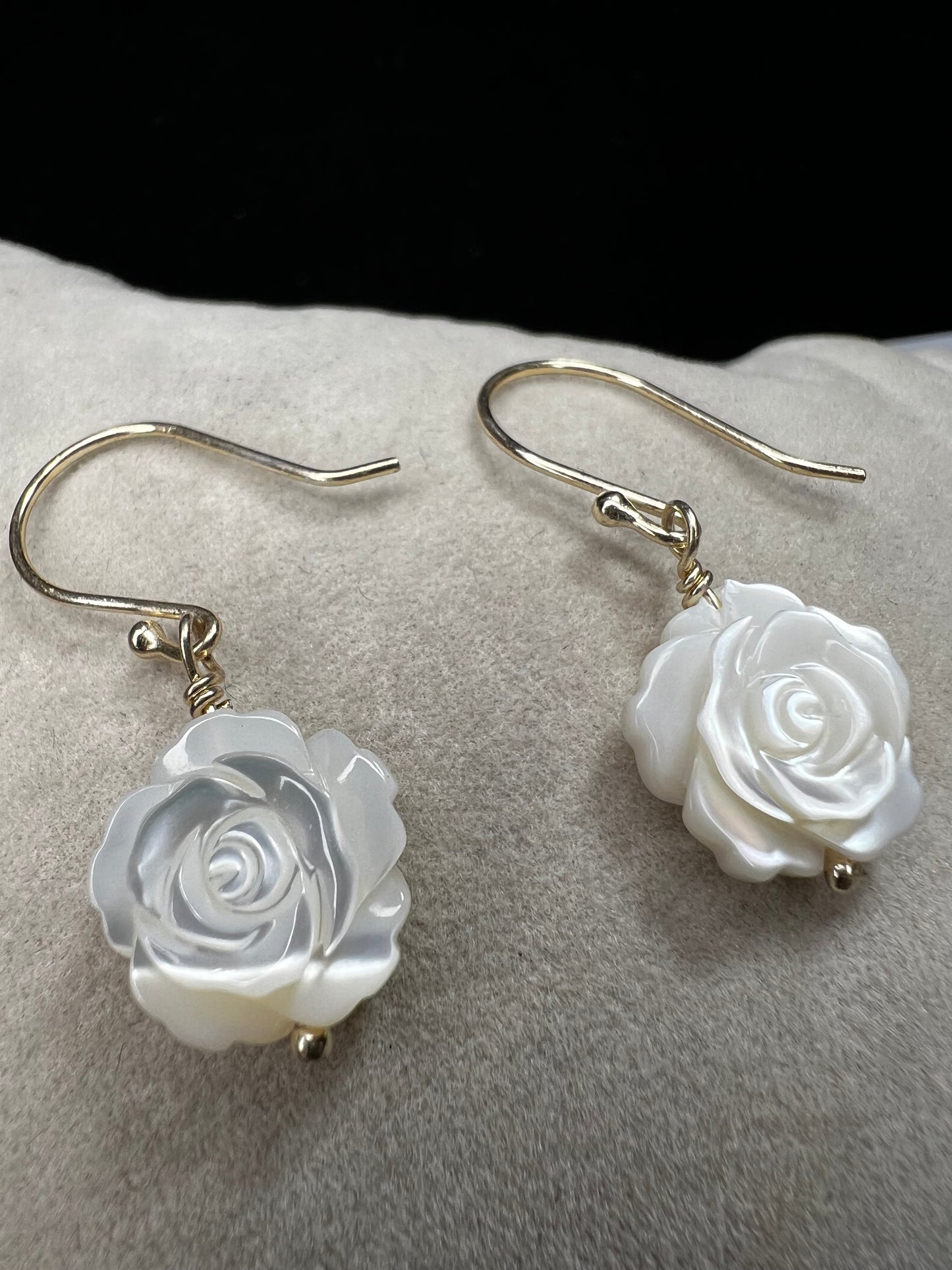 This stunning pair of earrings features a mother of pearl rose on each with gold washed sterling silver.
