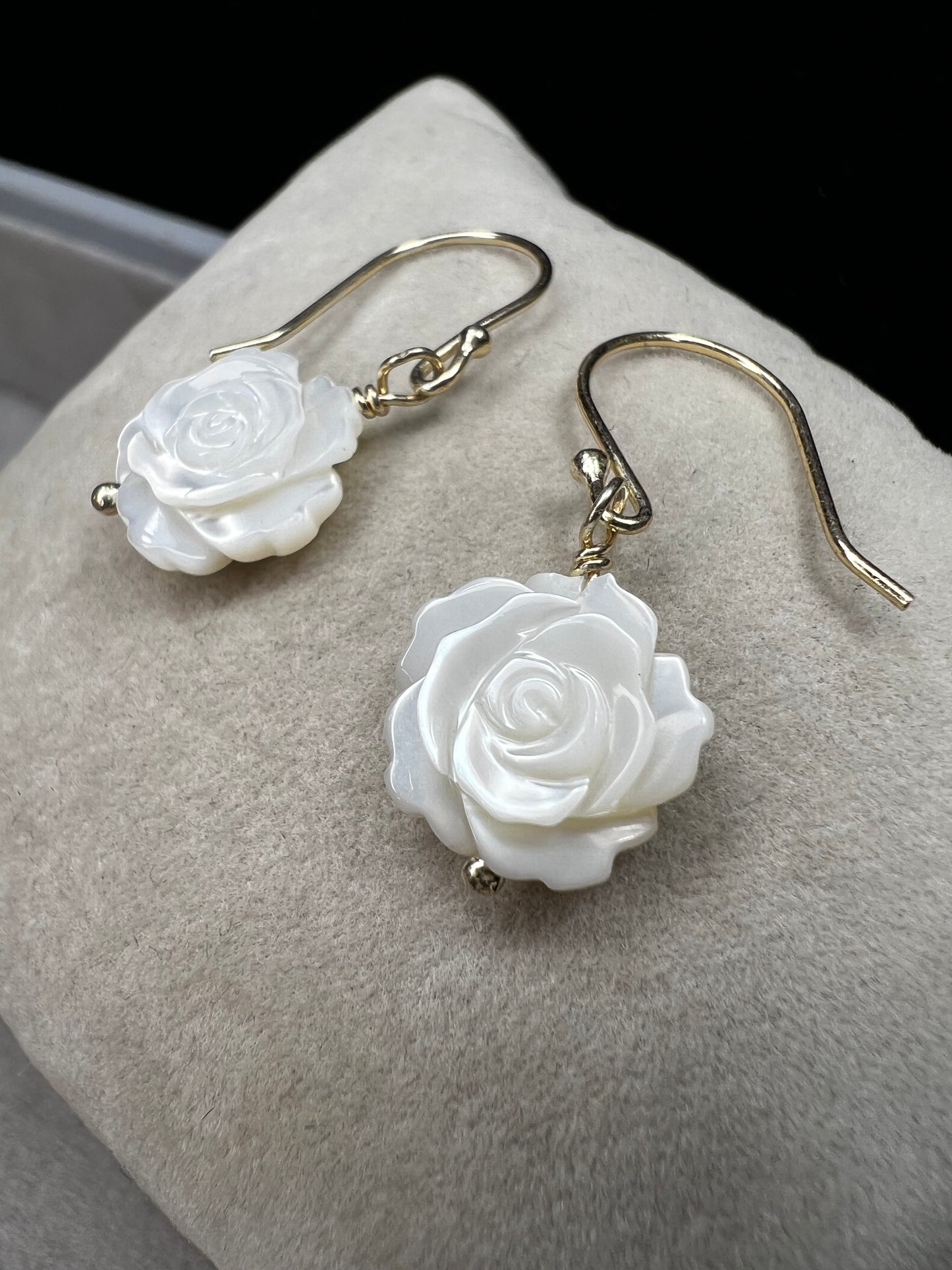 This stunning pair of earrings features a mother of pearl rose on each with gold washed sterling silver.