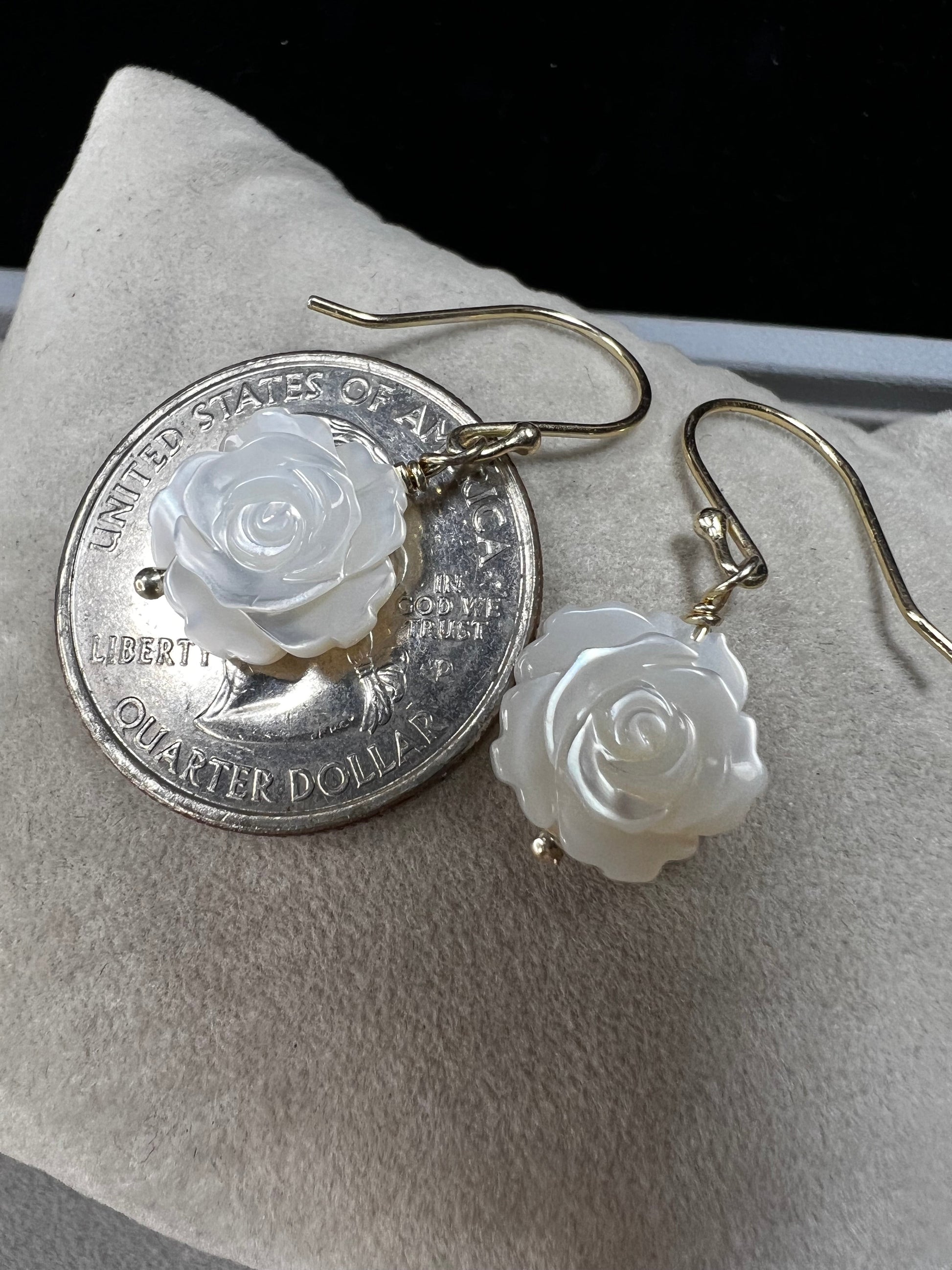 This stunning pair of earrings features a mother of pearl rose on each with gold washed sterling silver.