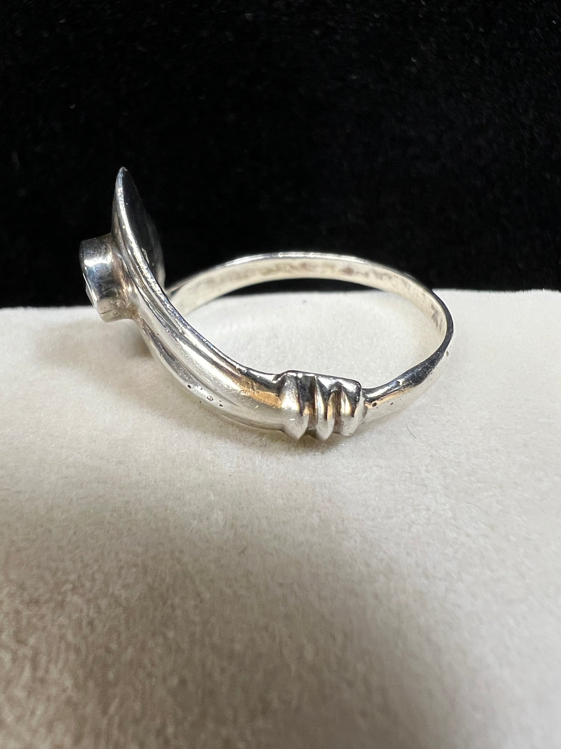 Add some individuality to your outfit with this sterling silver ring. Its unique design features an amethyst front and center.