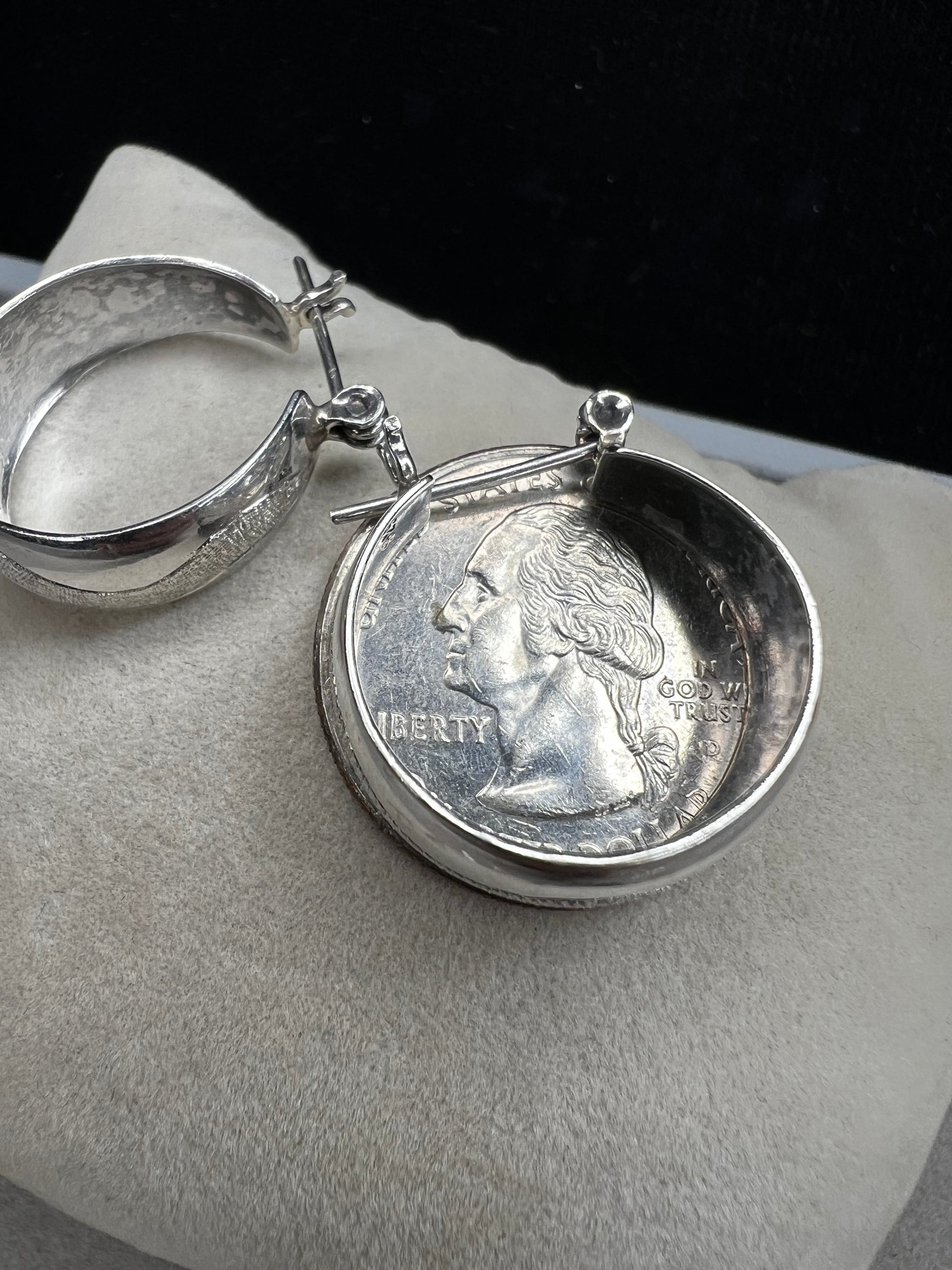 This vintage pair of sterling silver hoop earrings feature an etched design that resembles a snake wrapping around each earring.
