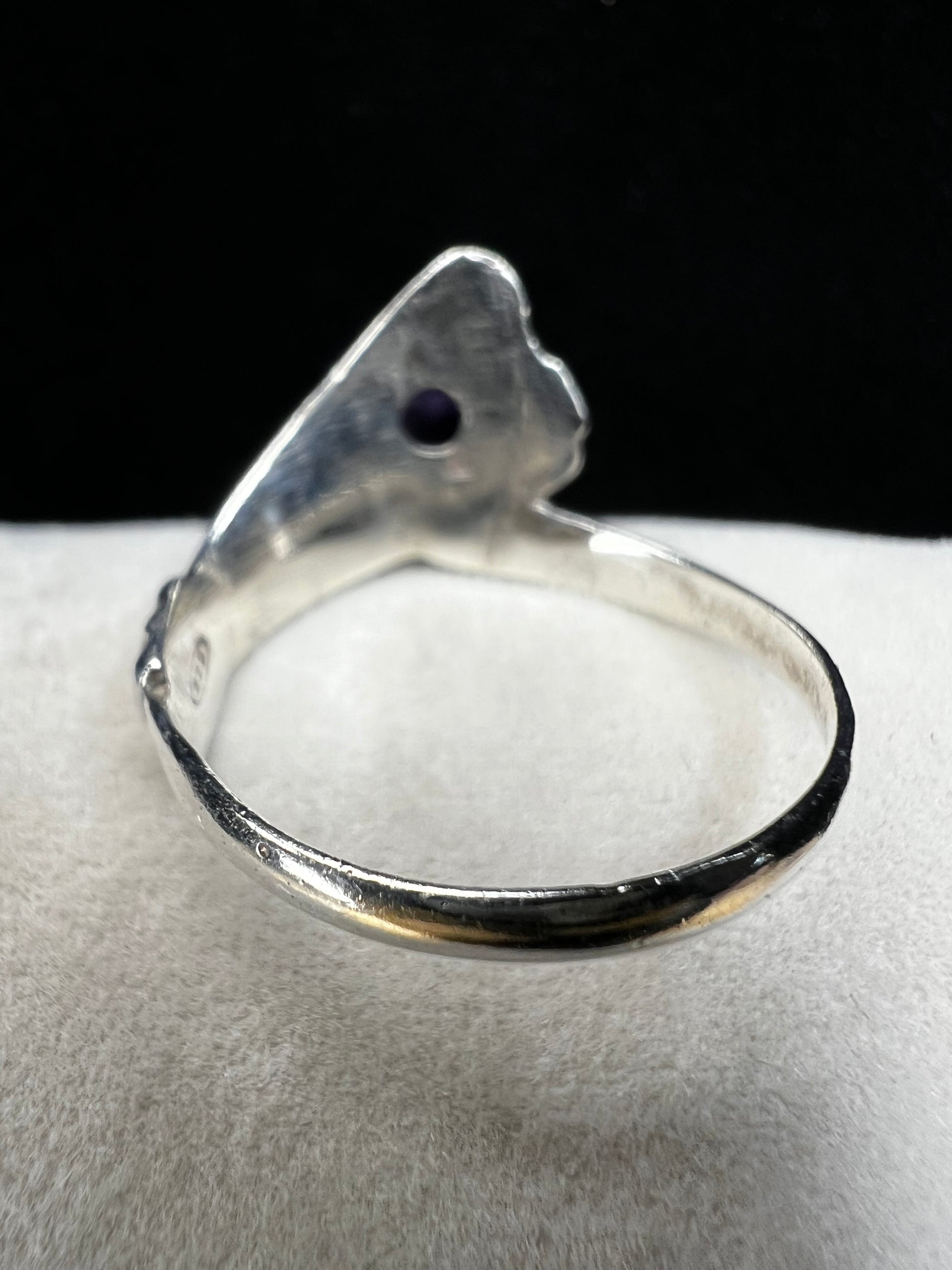 Add some individuality to your outfit with this sterling silver ring. Its unique design features an amethyst front and center.