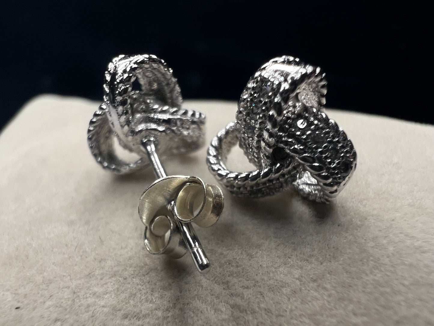Sterling silver and diamond earrings. Perfect for a special event or just a night out. The diamonds are set along the knotted ribbon design, ready to catch just the right light for a little flash.