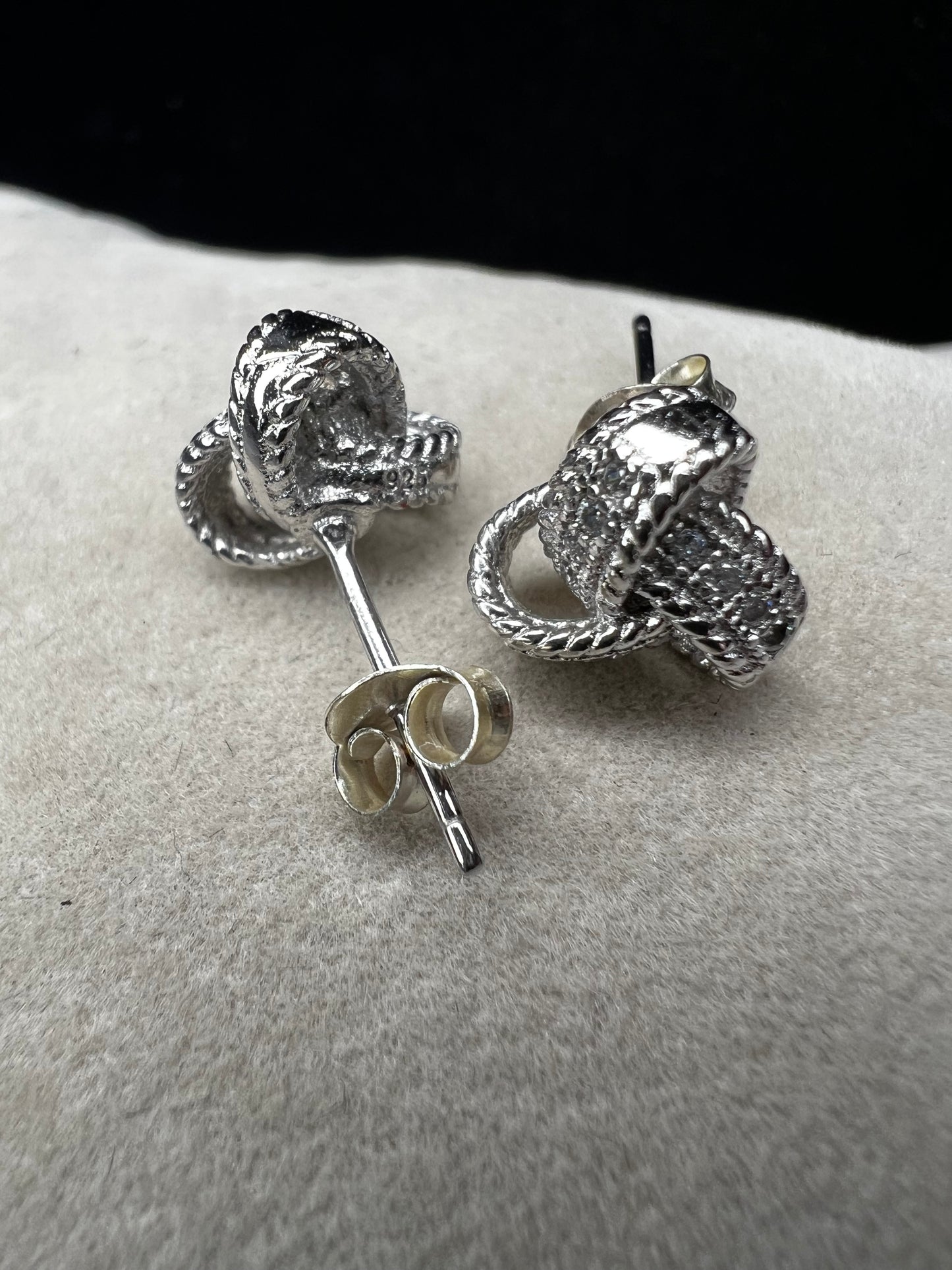 Sterling silver and diamond earrings. Perfect for a special event or just a night out. The diamonds are set along the knotted ribbon design, ready to catch just the right light for a little flash.