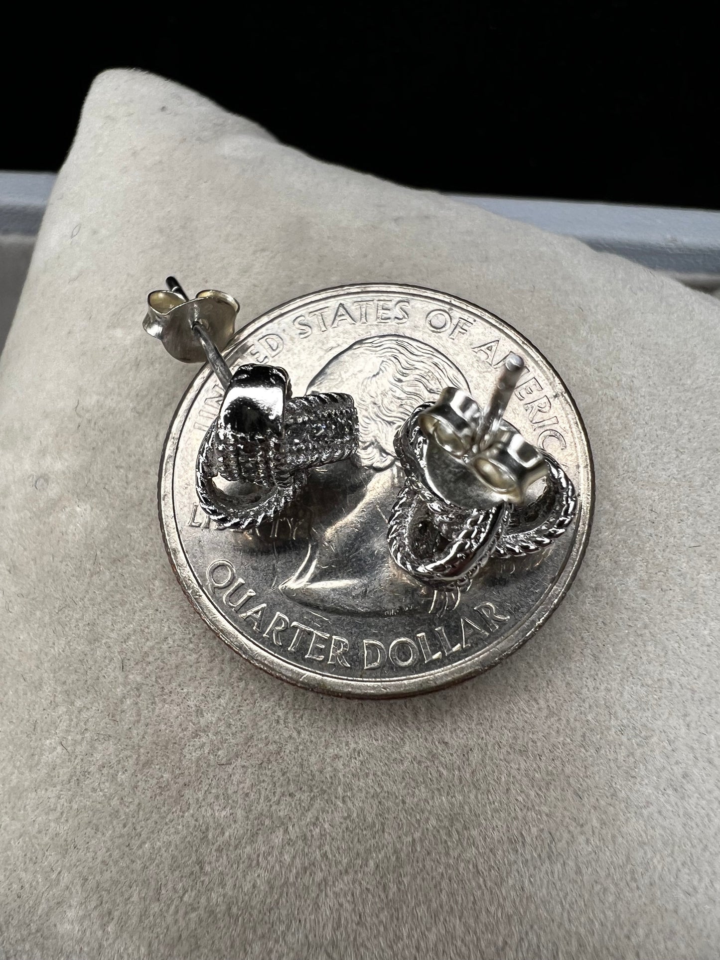 Sterling silver and diamond earrings. Perfect for a special event or just a night out. The diamonds are set along the knotted ribbon design, ready to catch just the right light for a little flash.